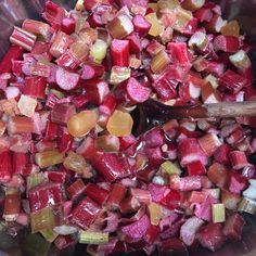 chopped beets and carrots in a bowl with a wooden spoon