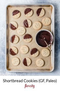 a cookie sheet with cookies and chocolate spread on it