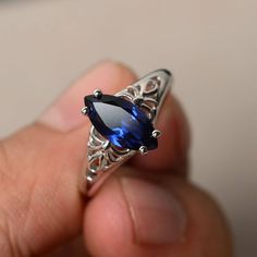 This is a gorgeous handmade creation. Its beauty is its simplicity & Elegance. The 6*12 mm marquise shape faceted lab Sapphire is crafted in solid sterling silver and with rhodium plated. Main stone weight about 2.33 ct. All item is sent in a beautiful gift box If you have any idea of design your ring,pls contact me directly. You can realize more lovely stuff clicking the link https://www.etsy.com/shop/knightjewelry?refshopsection_shophome_leftnav Please leave the correct address and you pho Blue Topaz Rings, Sapphire Silver Ring, Black Spinel Ring, Swiss Blue Topaz Ring, Gemstone Wedding Rings, Sapphire Wedding Rings, Blue Gemstone Rings, Filigree Engagement Ring, London Blue Topaz Ring