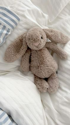 a stuffed animal sitting on top of a bed