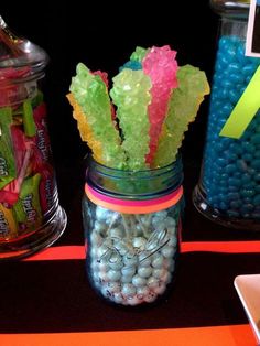 there are candy and candies in jars on the table