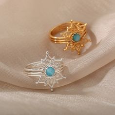 Our Blue Opal Lotus Flower Ring is an excellent choice for anyone looking to add a bohemian touch to their jewelry collection. This stunning ring features a soothing blue opal hue reminiscent of the ocean's calming waters, making it an excellent choice for those seeking a serene and tranquil vibe in the center, surrounded by intricate lotus petals that symbolize enlightenment, purity, and rebirth. With its timeless design and high-quality craftsmanship, our Blue Opal Lotus Flower Ring is the per Adjustable Bohemian Blue Flower Ring, Light Blue Round Bohemian Jewelry, Bohemian Blue Stackable Round Rings, Bohemian Flower Ring With Gemstone, Adjustable Bohemian Opal Ring, Bohemian Gold Opal Ring, Blue Bohemian Moonstone Ring, Bohemian Opal Ring, Bohemian Blue Stackable Rings