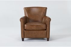 a brown leather chair sitting on top of a white floor