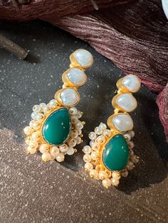 One of our favorite picks! The gorgeous studs are beautifully handcrafted by our skilled Indian craftsmen from Jaipur in the finest quality of gemstones and gold plated. Material: Brass, Pearls, Gold Polish The length of the earrings is 5.5 cm  The weight of the earrings is 22 grams per pair Gemstone Earrings For Festive Celebrations, Gold Earrings With Stones For Festive Occasions, Elegant Handmade Bridal Earrings For Diwali, Handmade Gold-plated Festive Earrings, Festive Handmade Gold-plated Earrings, Festive Traditional Earrings With Stones, Festive Gemstone Earrings For Celebration, Festive Gemstone Danglers For Gifting, Temple Jewelry Gemstone Danglers For Gift