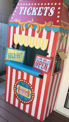 an old fashioned carnival ticket booth is painted red, white and blue