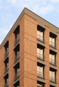 a tall brick building with balconies and windows