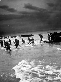 black and white photograph of people in the ocean