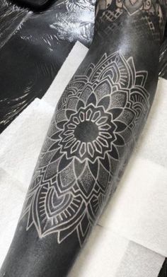 a person with a black and white tattoo on their arm