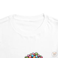 Elevate your child's style game with our Airlume Combed Toddler Short Sleeve Tee in Various Colors! This Bella Canvas tee is crafted from 100% Airlume combed and ring-spun cotton jersey, ensuring a soft and comfortable fit for your little one. Whether your toddler prefers bold hues or classic neutrals, our tee comes in a wide array of colors to suit every taste.Featuring an extra light fabric weight of 3.9 oz/yd² (132 g/m²) and a tear-away label for added comfort, this tee is perfect for everyda Casual White Top For Birthday, Playful White Long Sleeve T-shirt, Multicolor Cotton Tops For Birthday, White Crew Neck Top For Birthday, White Relaxed Fit Top For Birthday, Playful White T-shirt For Spring, Fun Cotton Tops For Easter, White Graphic Tee For Birthday, Playful White Top For Birthday