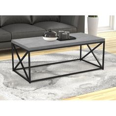 a gray coffee table sitting on top of a rug