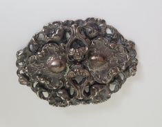 "Vintage antique silver tone floral brooch. Victorian style. Reminded me of steam punk without the gears.  A large statement piece with a lot of fine detail. The piece measures 2 3/8\" tall by 3 7/16\" wide. In good vintage condition. Please see photos.  Please browse our other items as we do combine shipping for added savings." Ornate Antique Silver Brooches For Formal Occasions, Ornate Antique Silver Brooch For Formal Occasions, Antique Silver Ornate Brooch For Formal Occasions, Victorian Antique Silver Wedding Brooches, Antique Silver Brooches With Intricate Design, Victorian Antique Silver Brooches For Collectors, Victorian Antique Silver Brooches, Handmade Ornate Sterling Silver Brooches, Antique Silver Metal Brooch