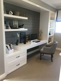 a home office area with desk, chair and bookshelf on the wall behind it