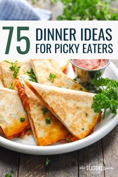 a white plate topped with quesadillas and salsa