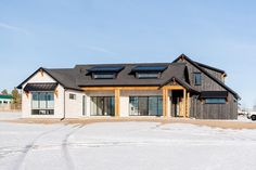 a house that is in the snow with lots of windows on top of it,