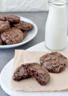 two plates with chocolate cookies and a glass of milk