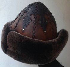 "Completely hand stitched Handmade This Leather hat is extremely thick and very warm.Made Genuine leather and Sheep Fur. Please be sure to measure the size of your head before buying. Measuring; Measuring for your head size is, You can use a tape measure (or a length of string that you will have to hold up to a tape measure) to determine the length. Place the string or tape around your head about 1/8\" above your ear, across the mid-forehead, completely circling your head. Hold the tape firmly, Handmade Artisan Hat Bands For Winter, Handmade Curved Brim Costume Hat, Traditional Handmade Costume Hats And Headpieces, Handmade Costume Hat With Curved Brim, Artisan Handmade Hats For Ceremonial Occasions, Unique Handmade High Crown Hat, Handmade Brown Brimmed Costume Hats And Headpieces, Traditional Handmade Brown Hat Bands, Handmade Cap-style Hat For Costume