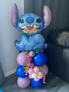 an inflatable balloon shaped like stitcher from stitchers is sitting on top of balloons