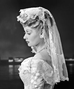 an old photo of a woman wearing a veil