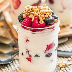 yogurt parfait with berries and granola in a jar on a table