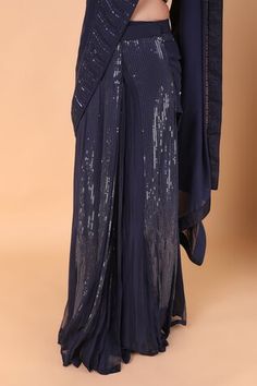 Navy blue pre-draped saree with tonal sequin embroidery. Paired with a blouse with all over floral vine embroidery using sequin, stone. - Aza Fashions Blue Draped Blouse Piece For Evening, Sequined Draped Dress For Diwali, Evening Dupatta With Mirror Work And Draped Style, Evening Draped Dupatta With Mirror Work, Formal Blue Draped Saree, Eid Evening Draped Dupatta, Blue Formal Pre-draped Saree, Formal Blue Pre-draped Saree, Draped Blouse Piece For Evening Festivals