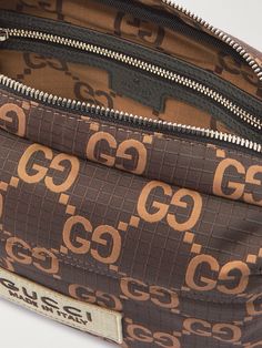 The 'double G' monogram, from the initials of founder Guccio Gucci, has been used by the house for almost a century. Made from ripstop, this messenger bag is jacquard-woven with the emblem and appliquéd with an additional logo patch for good measure. The main compartment is spacious enough for your essentials, and there's an external zipped pocket for smaller items. Brown Monogram Canvas Shoulder Bag With Monogram Print, Brown Monogram Canvas Shoulder Bag, Everyday Rectangular Shoulder Bag With Logo-jacquard Lining, Brown Monogram Shoulder Bag, Designer Brown Bags With Embroidered Logo, Brown Travel Bag With Embroidered Logo, Designer Monogram Shoulder Bag For Travel, Gucci Rectangular Bag With Embroidered Logo, Designer Brown Monogram Bag