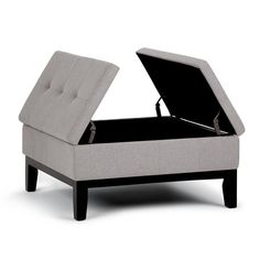 a grey ottoman bed with an open lid on the top and bottom part in black