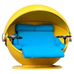 a yellow and blue chair sitting inside of a ball