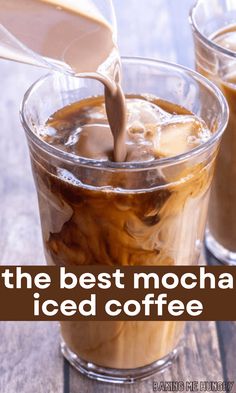 two glasses filled with iced coffee on top of a wooden table next to each other