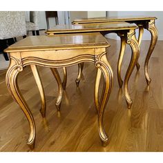 two wooden tables sitting on top of a hard wood floor