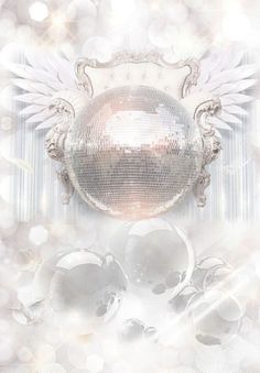 a shiny disco ball with angel wings on it's side and some lights in the background