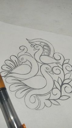 a pencil drawing a peacock on top of a piece of paper with an ink pen