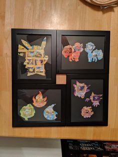 four framed pictures with different types of paper cut outs on the side of a wall