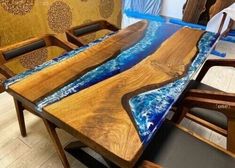 a table that is made out of wood and has an ocean scene on the top