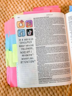 an open book with colorful sticky notes on it