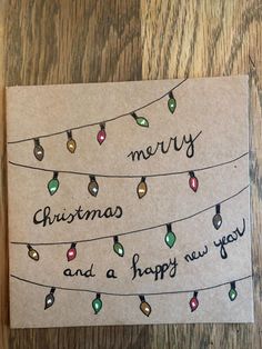 a christmas card that says merry and a happy new year hanging from a line of lights