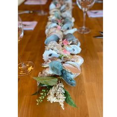 a long table with flowers and wine glasses on it