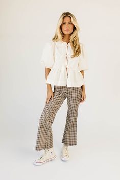 fall called + said you needed some high-waisted plaid pants. featuring a retro-inspired brown + red plaid pattern, these flared bottoms make your body look bomb. the perfect statement pants for date nights, office outfits, + everything in between; we love them dressed up with a blouse + heels, or down with a graphic tee + sneakers. burgundy // high waisted, flare leg, one bottom fly zip, back pockets paired with our moonlight blouse + kacey knit top model is 5'8" + wearing a small measurements a Chic Plaid Wide Leg Pants, Flared Bottoms, Statement Pants, Plaid Trousers, Peplum Styles, Date Nights, Puff Sleeve Blouse, Plaid Pants, Office Outfits