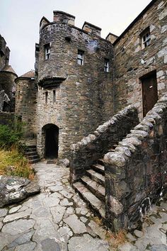 an old stone castle with stairs leading up to it