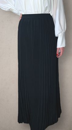 Modest high rise maxi skirt. Elastic waistband. Pleated. Fully lined for full coverage. Flowy Wide Leg Maxi Skirt For Night Out, Flowy Wide-leg Maxi Skirt For Night Out, Long Skirt With Elastic Waistband For Night Out, Elastic Long Skirt For Night Out, Spring Workwear Pleated Full-length Skirt, Full-length Pleated Skirt For Spring Workwear, Black Full-length Flowing Pleated Skirt, Relaxed Wide Leg Maxi Skirt For Night Out, Spring Full-length Pleated Skirt For Work