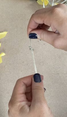 a person holding a toothbrush in their left hand with blue nail polish on it