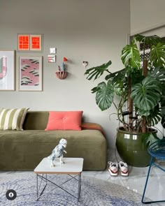 a living room filled with furniture and plants