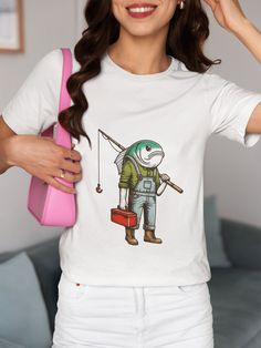 Dive into the quirky world of fishing with our unique Fish-Headed Fisherman T-Shirt! This whimsical and funny graphic tee features a fisherman with a fish head, carrying a red toolbox and a fishing rod. Perfect for fishing enthusiasts, outdoor adventurers, or anyone with a great sense of humor. We utilize the authentic Bella Canvas 3001 brand, renowned for its UNISEX design, making it one of the most sought-after shirts in the market. Prior to placing an order, kindly refer to our size chart. It Casual Crew Neck Fishing T-shirt, Casual Crew Neck T-shirt For Fishing, Casual Pre-shrunk T-shirt For Fishing, Graphic Print Short Sleeve T-shirt For Fishing, Graphic Print Crew Neck T-shirt For Fishing, Graphic Tee T-shirt For Fishing, Graphic Tee Short Sleeve T-shirt For Fishing, Short Sleeve Fish Print T-shirt For Fishing, White Cotton T-shirt For Fishing