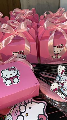 pink hello kitty boxes with bows and stickers on them