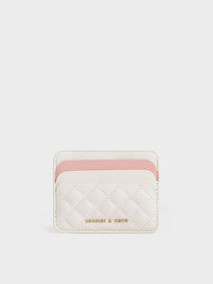 This product is made with at least 20% sustainable materials by weight. CHARLES & KEITH uses recycled, degradable, organic, and water-based materials in our eco-conscious collection. Small but mighty, this cardholder is perfect for the modern woman. Featuring a two-toned finish that accentuates elegant cream with a pink accent, this cardholder exudes classic femininity. The quilted texture adds a luxurious element to the simple design, along with a charming tactility. Offering the functionality of six card slots and one middle compartment for loose change or bills, it will hold your valuables while being compact enough to fit in your smaller bags. Aesthetic Shoulder Bag, Luxury Bags Collection, Small But Mighty, Charles Keith, Pink Accents, Card Holder Wallet, Eco Conscious, Sustainable Materials, Small Bag