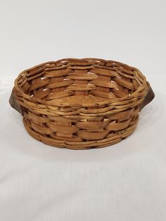 an empty basket sitting on top of a white table