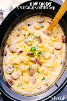 a crock pot filled with corn and sausages, garnished with parsley