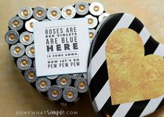 a heart shaped box with a sign that says roses are red violets are blue here