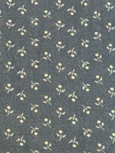 a close up view of a blue and white fabric with small flowers on the side