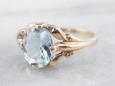 This stunning aquamarine has been set into this Retro era solitaire ring. The cool blue tones contrast beautifully with the warmth of the vintage mounting, while the tapered shoulders draw light into the sparkling gem. This is a lovely piece that is pretty enough to wear alone, yet versatile enough to stack with other rings!Metal: 10K Yellow GoldGem: Aquamarine 1.37 CaratsGem Measurements: 8.5 x 6.9 mm, OvalRing Size: 5.25Marks: "10K" Stamped on the inside band Classic Blue Topaz Solitaire Ring, Formal Light Blue Topaz Ring, Classic Blue Topaz Birthstone Ring, Classic Blue Topaz Birthstone Ring, Round Cut, Classic Round Cut Blue Topaz Birthstone Ring, Classic Birthstone Ring With Round Cut Blue Topaz, Classic Light Blue Topaz Ring For Formal Occasions, Light Blue Topaz Ring For Formal Occasions, Formal Light Blue Topaz Ring Fine Jewelry