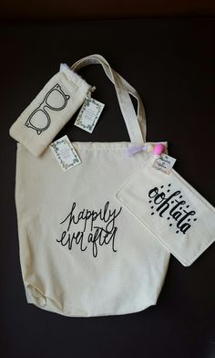 two white bags with black writing on them and tags attached to the handles that say happily fun day